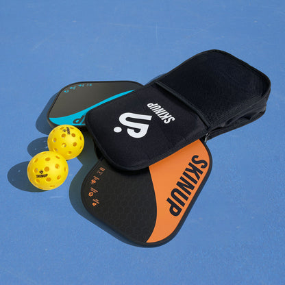 Kit pickleball 1 housse 2 balles 1 raquette Yin Yang orange et 1 bleue SKINUP SPORT – sur terrain