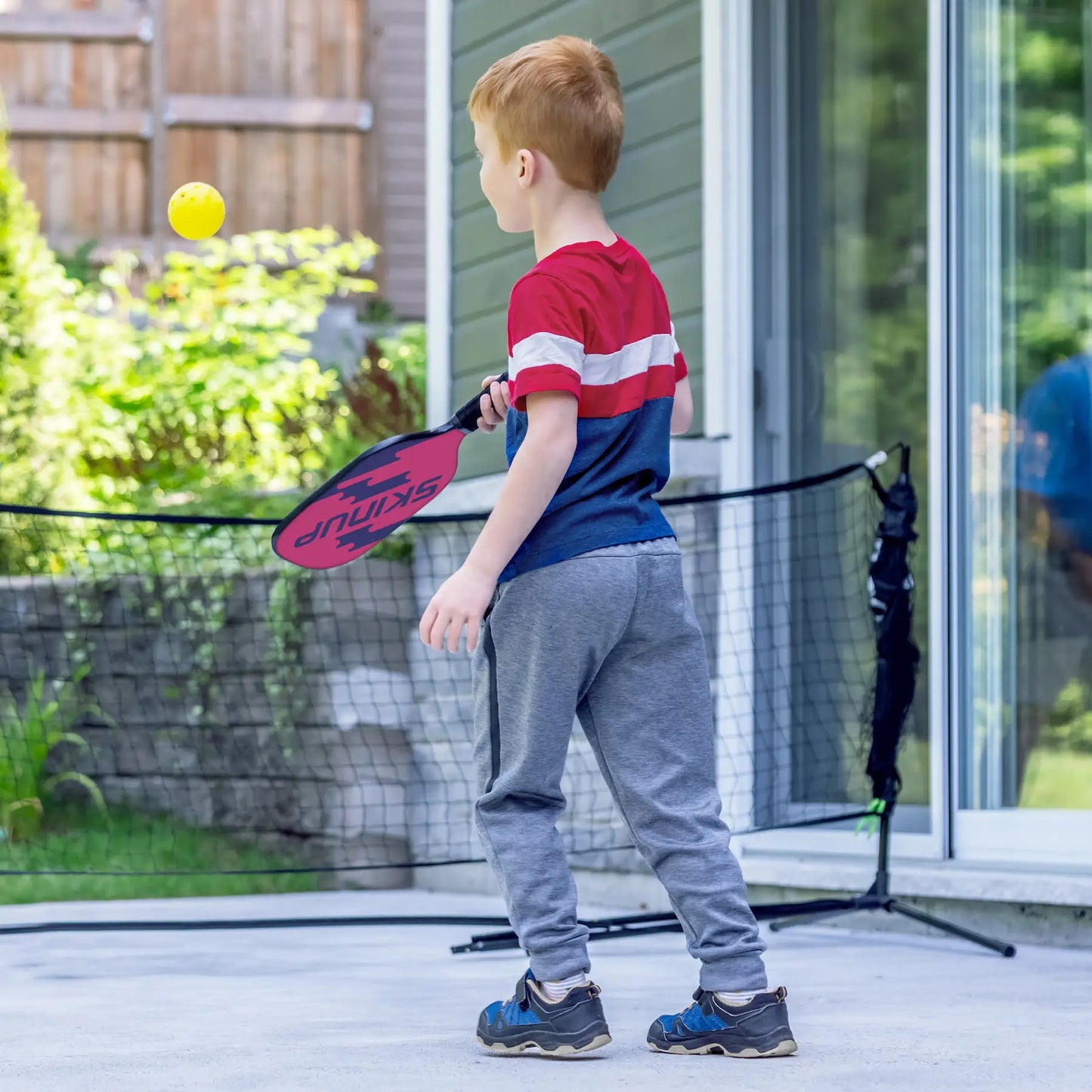 Raquette Kids+ Blanc Wave SKINUPSPORT en match - joueur en action
