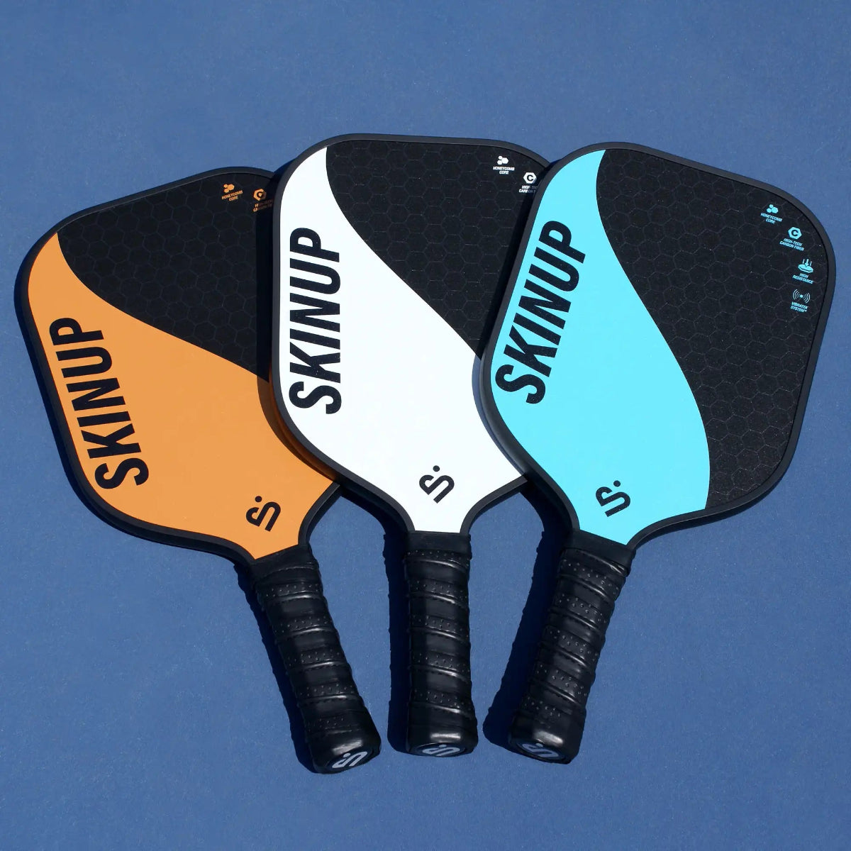3 raquettes Yin Yang orange blanche et bleue SKINUP SPORT
